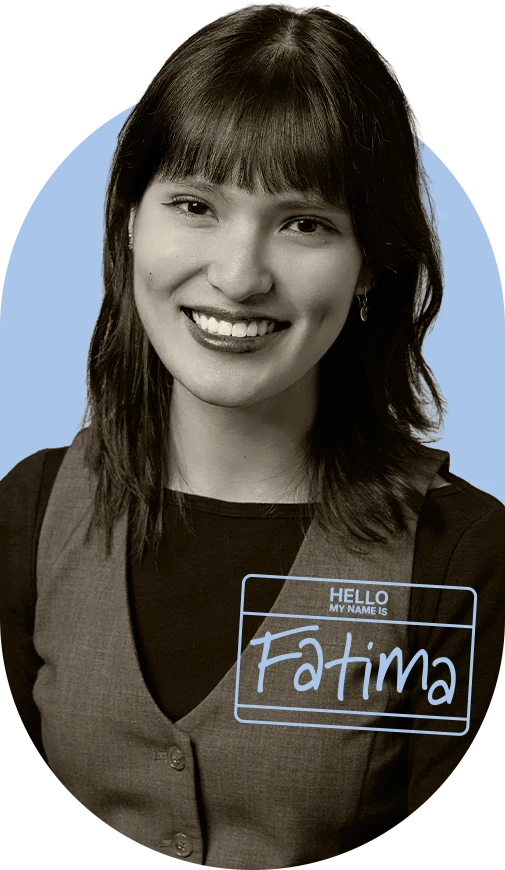 Fatima smiling, wearing a “Hello, my name is Fatima” name tag.